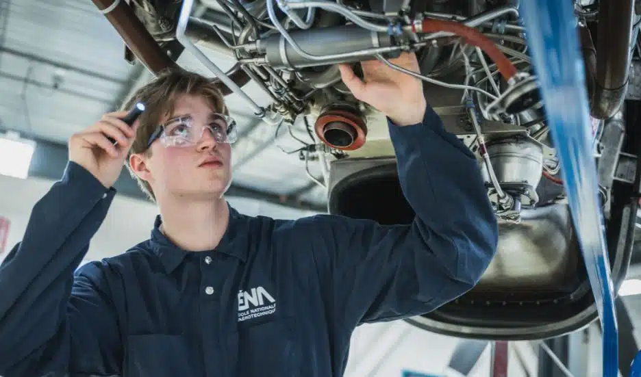 Étudiant en maintenance d'aéronefs inspectant un moteur d'avion